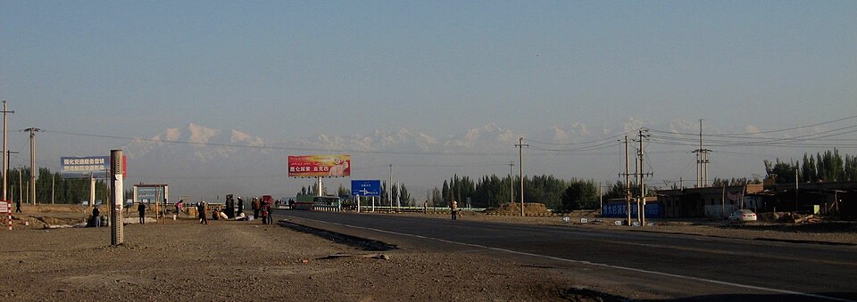 Snow-capped Tian Shan range rising beyond the farmland outside Aksu