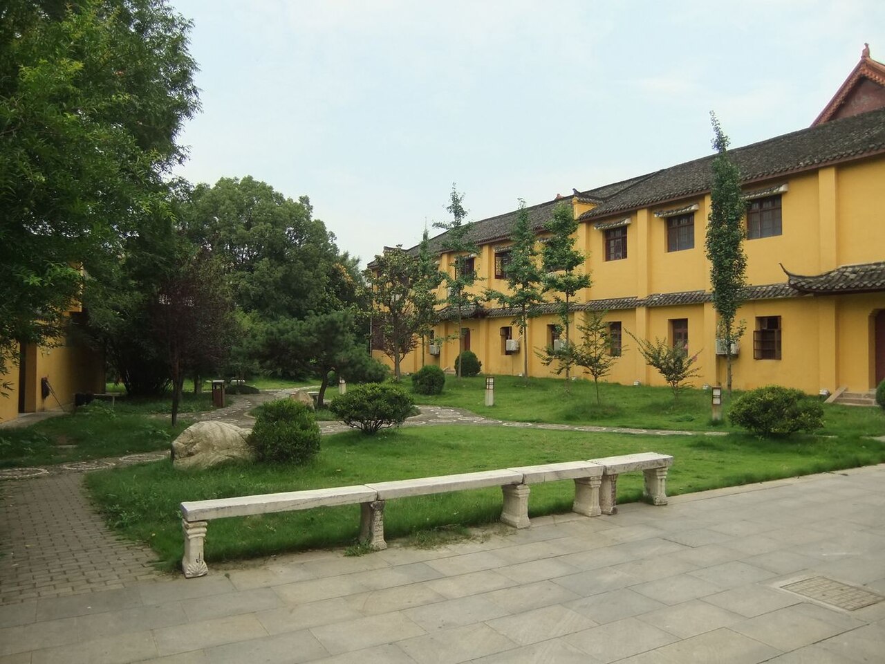 Quiet courtyard with incense burner and halls inside Yingjiang Temple