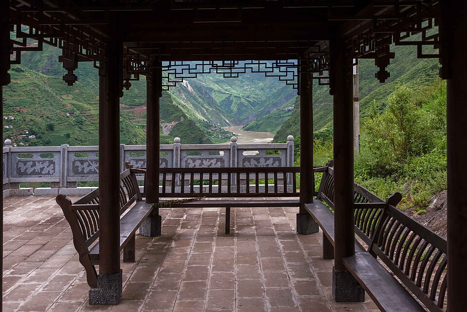 Street with low buildings and green hills behind in Baoshan, Yunnan