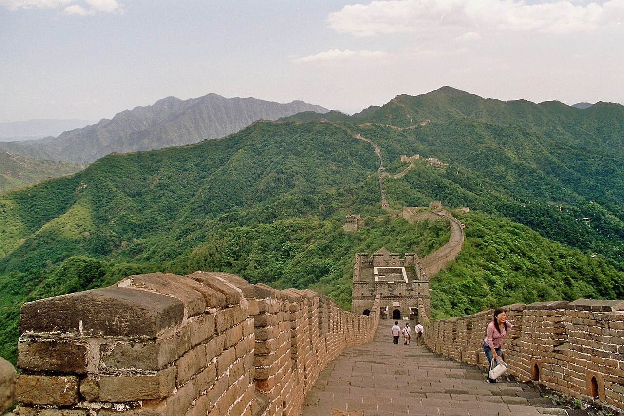 Mutianyu Great Wall curving along a mountain ridge above trees