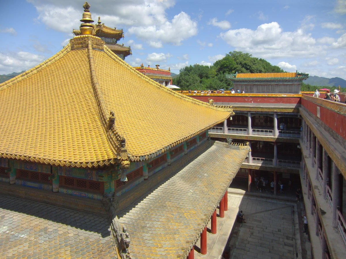 The gilded fish-scale roof of the Hall of All Dharmas Returning to One inside the Great Red Terrace