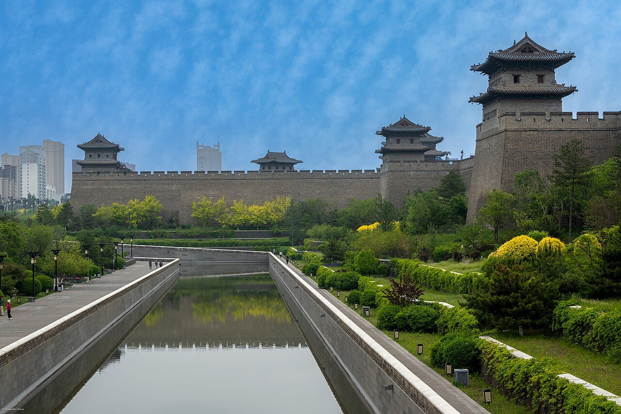 The rebuilt Datong city wall and gate towers beside the moat and a garden walkway