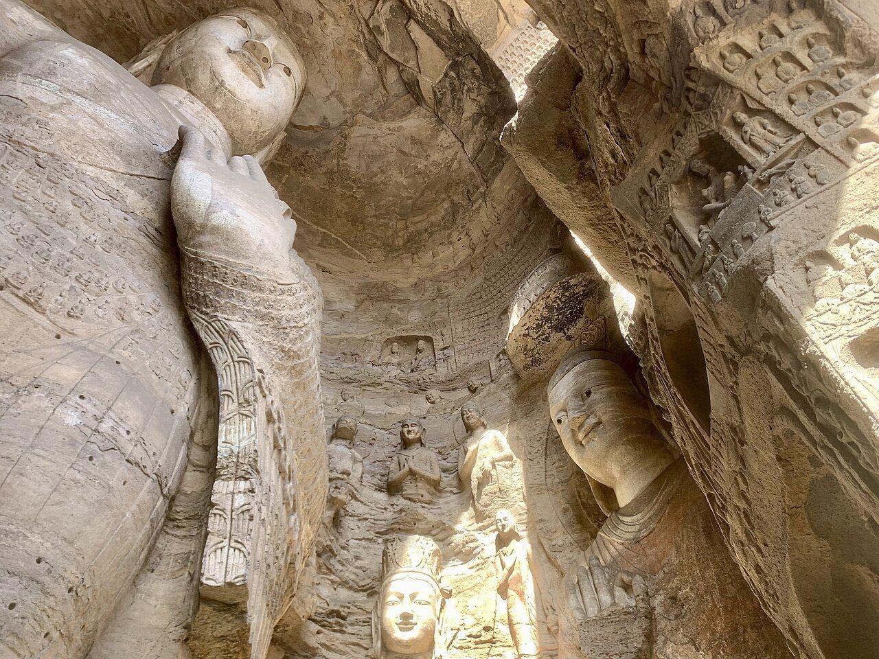 Weathered sandstone Buddha figures and niches inside a Yungang cave