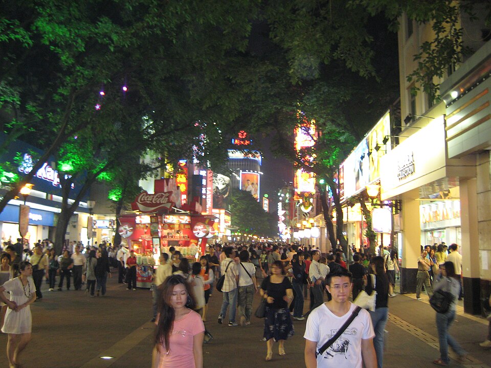 Beijing Road pedestrian mall lit with neon at night