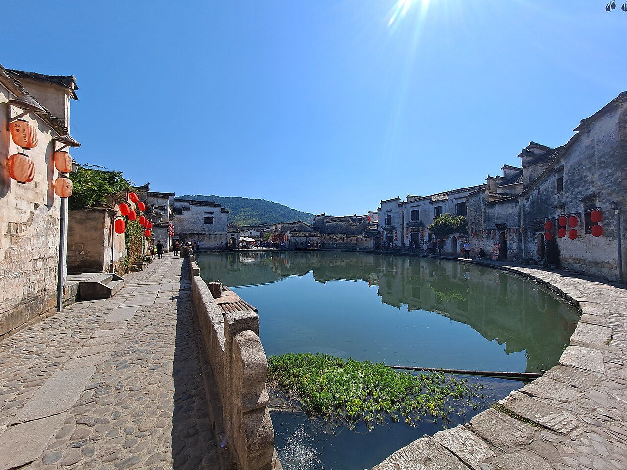 The half-moon shaped Moon Pond surrounded by houses in Hongcun