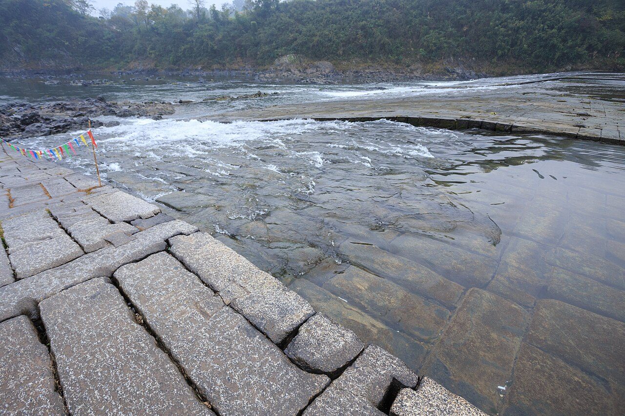 Water flowing over the stone blocks of Yuliang Dam