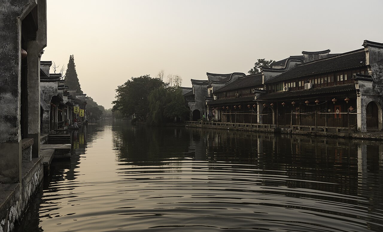 Waterside street with stone bridge in Nanxun water town