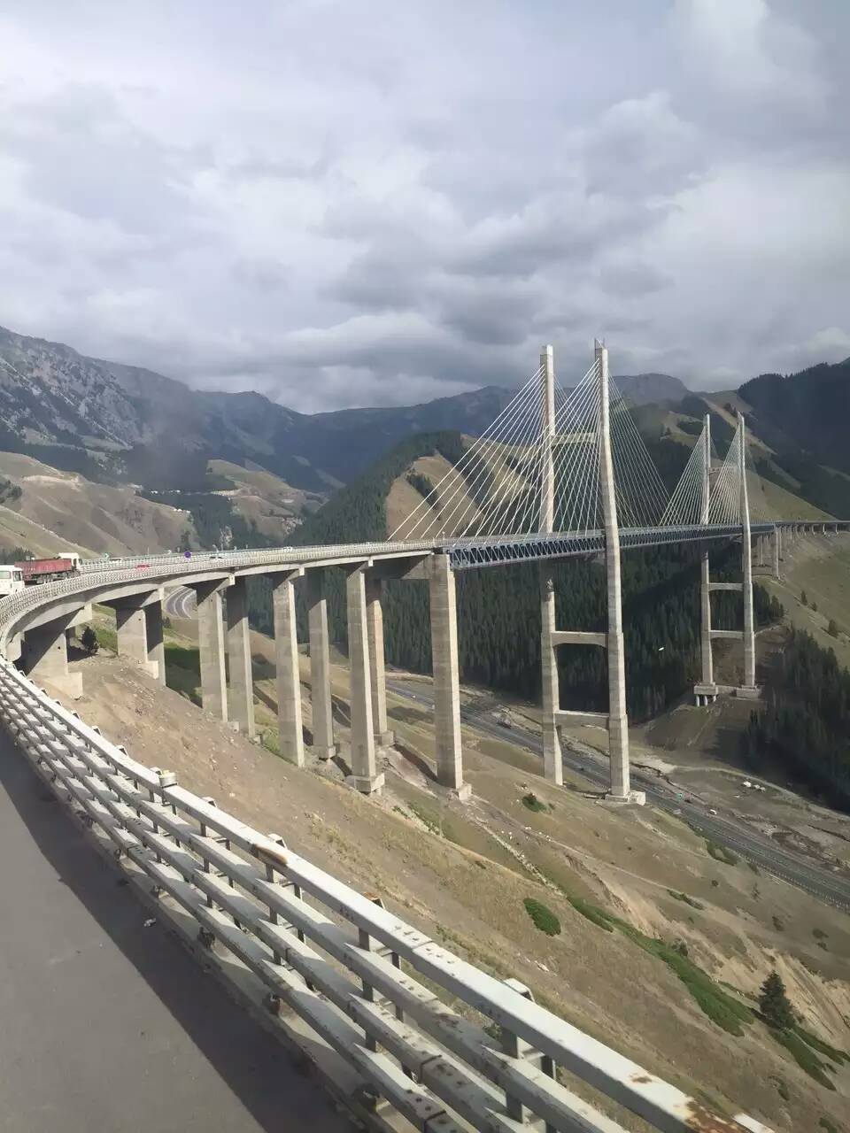 Guozigou Bridge spanning a deep mountain gorge on the road between Sayram Lake and Yining