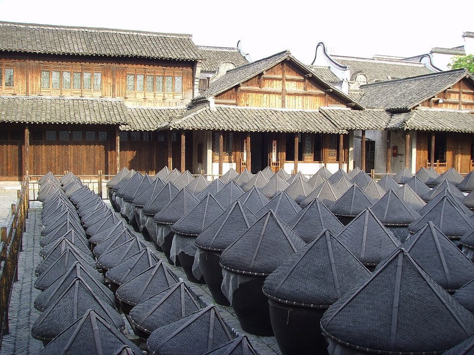 Rows of covered soy sauce fermentation vats in a courtyard in Wuzhen Xizha