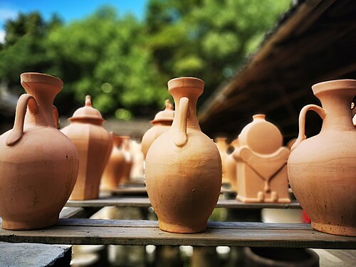 Shelves of unfinished porcelain cups and bowls in a Jingdezhen workshop
