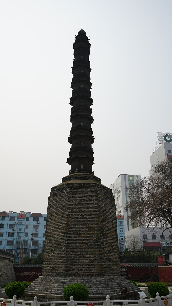Tall slender cast-iron pagoda of Chongjue Temple on its brick base