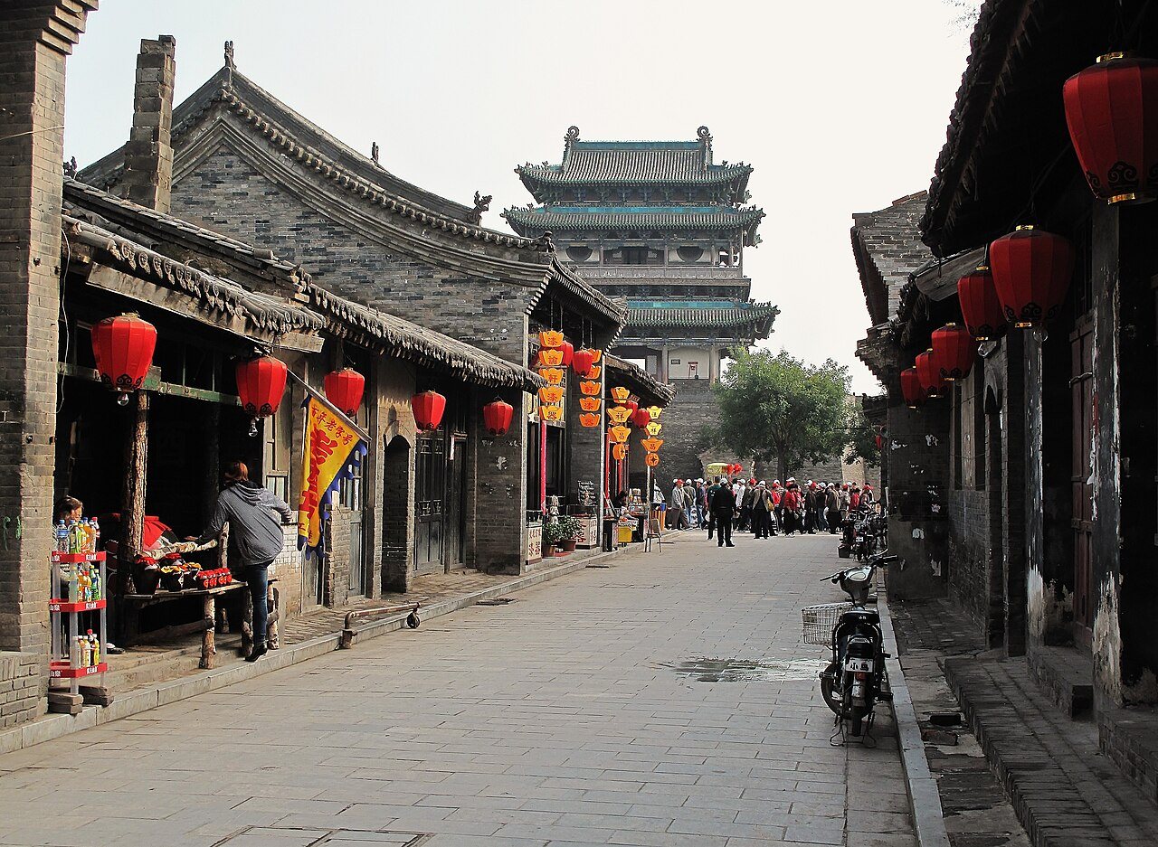 South Street in Pingyao with shops and red lanterns and the Market Tower rising at the end