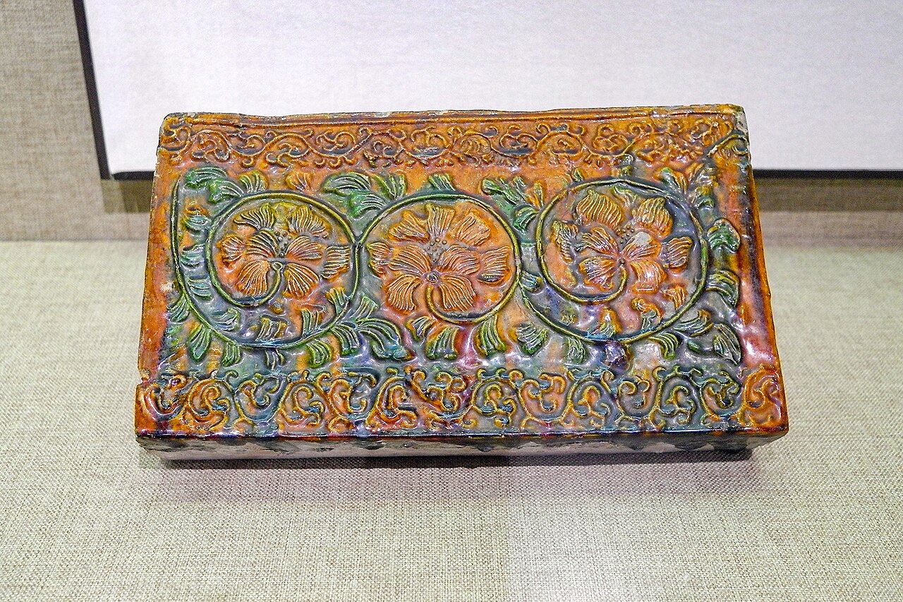 a brown glazed brick from the Iron Pagoda moulded with flower patterns