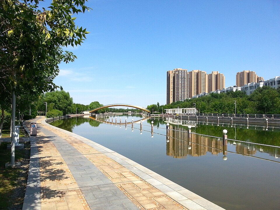 Tree-lined banks of the man-made Karamay River running through the city