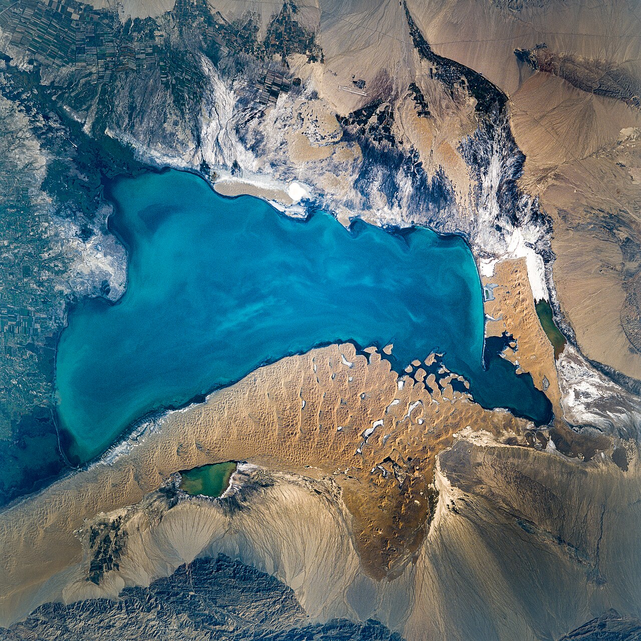 Satellite image of Bosten Lake and surrounding desert and mountains in Bayingolin