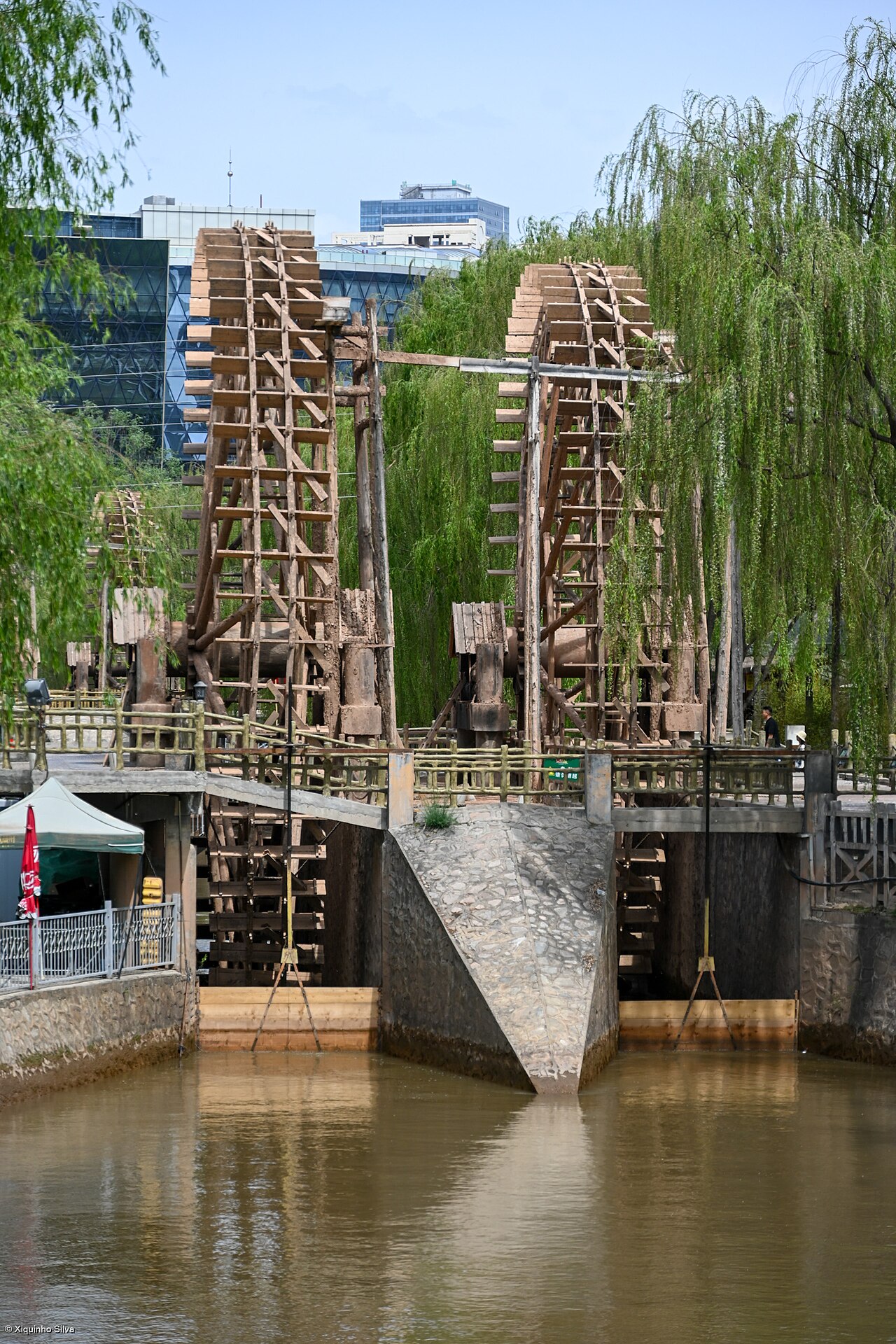 Giant wooden waterwheels turning beside the Yellow River in Lanzhou