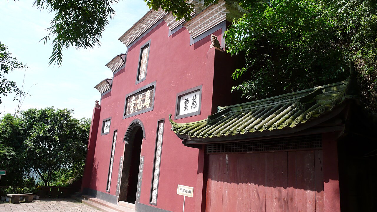 Halls of Wuyou Temple among trees on Wuyou Hill above the river