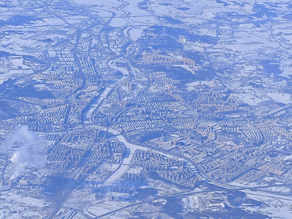 Aerial view of Liaoyuan city with apartment blocks and the river valley