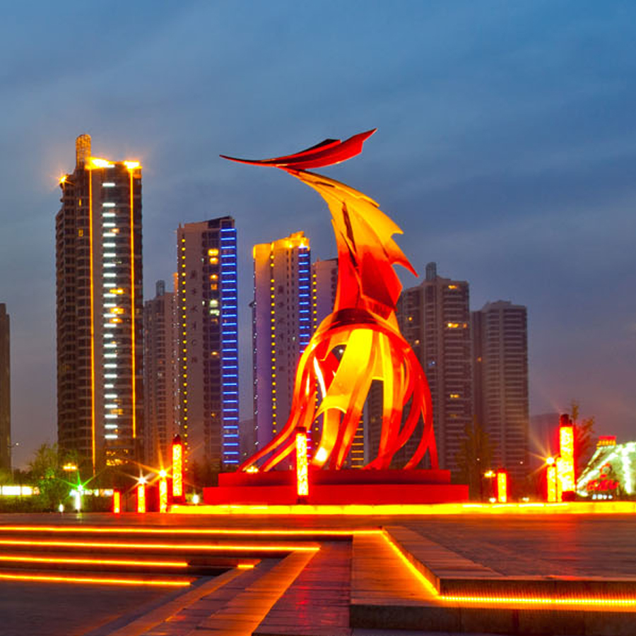 Lit buildings and plaza at Phoenix Square at night in Linyi
