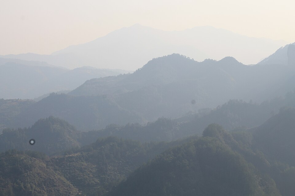 Forested mountain ridges and valley farmland in the Lishui countryside