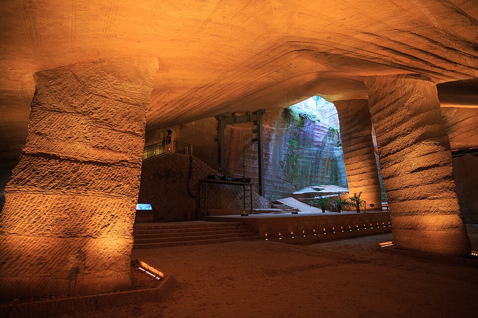 Stone pillars and chisel-marked walls inside a Longyou grotto cavern