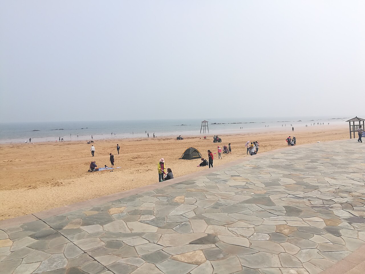Long curving beach shoreline in Rizhao under a clear sky