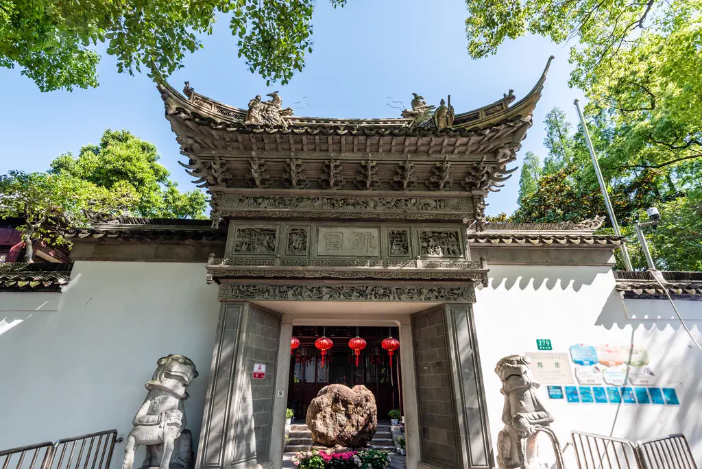 Carved stone gateway of Yu Garden with guardian lions
