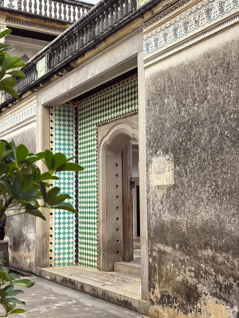 Colourful diamond-pattern tiles framing an arched doorway in the residence