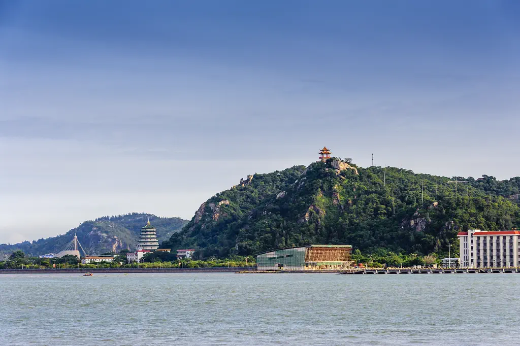 The green hill and its pavilion seen across the water from the city side