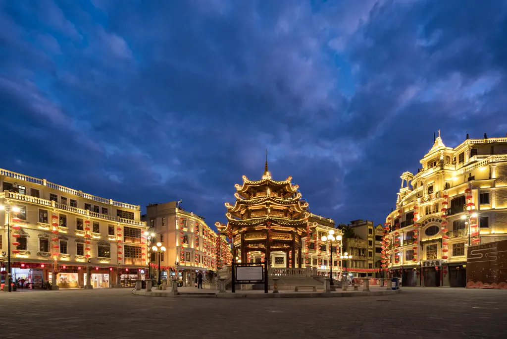 The pavilion and the square lit up at dusk