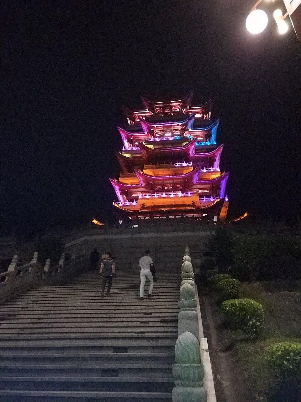 Shaoyang Tower lit up in gold against the night sky