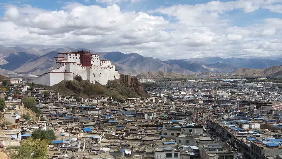 Shigatse Dzong fortress with white and red walls on a ridge above the city