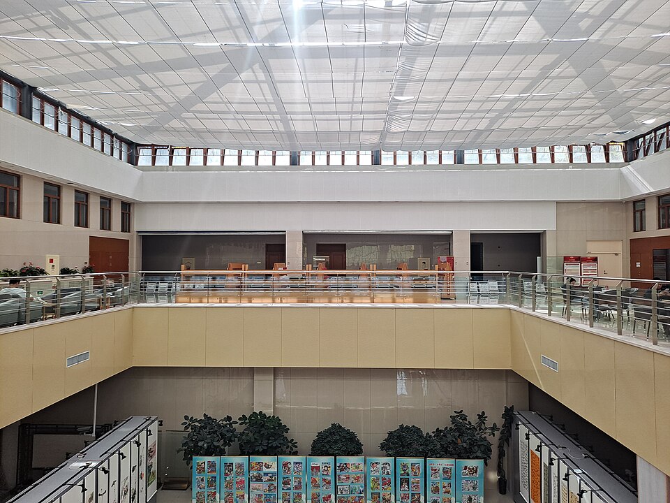 Modern Shuangyashan Library building with a large public square