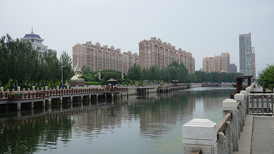 Nanhe River in Siping with a waterside boardwalk and apartment towers