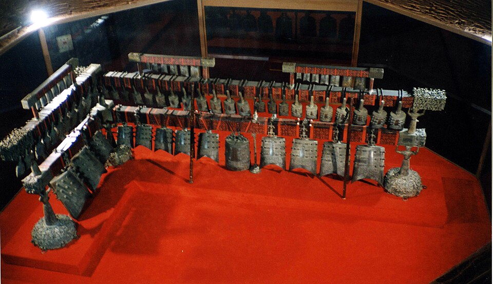 Set of bronze bianzhong bells hanging in tiers on a lacquered wooden frame