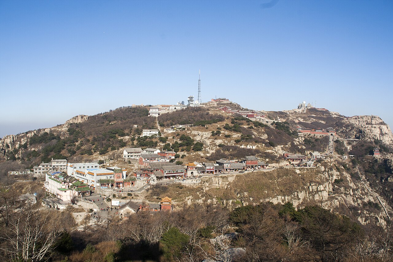 Stone paths and railings winding across the rocky summit area of Mount Tai