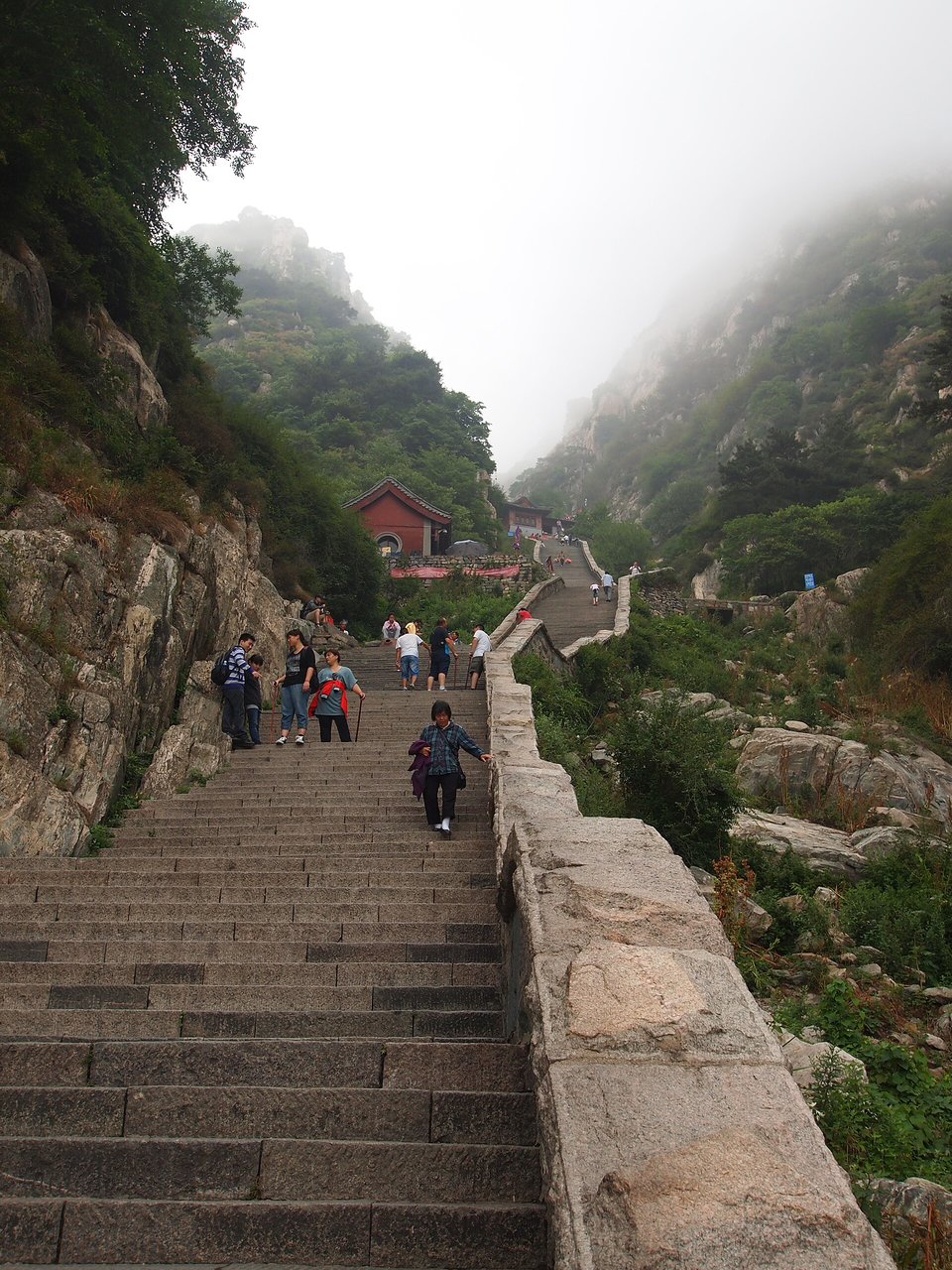 The steep stone stairway of the Eighteen Bends climbing into mist on Mount Tai