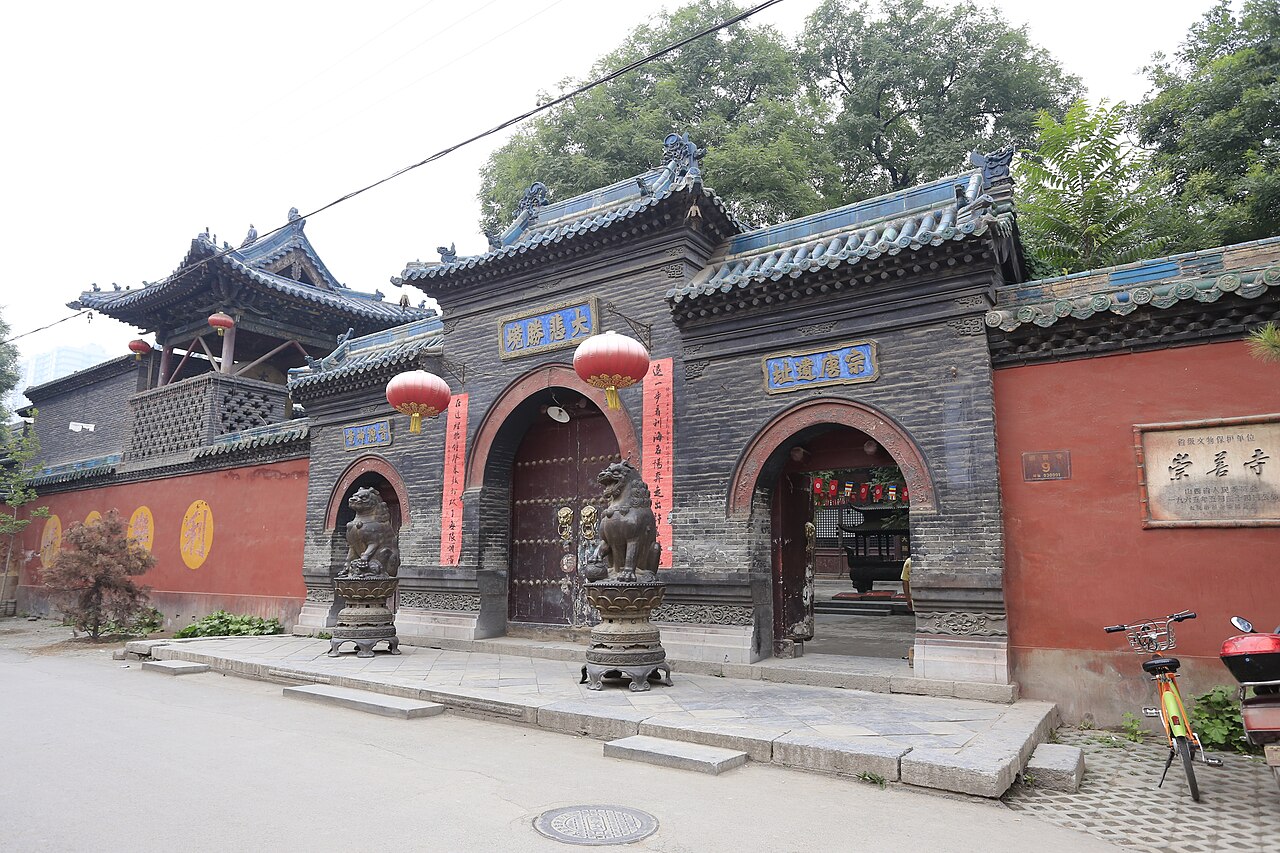 Grey-brick gate of Chongshan Temple with red lanterns in central Taiyuan