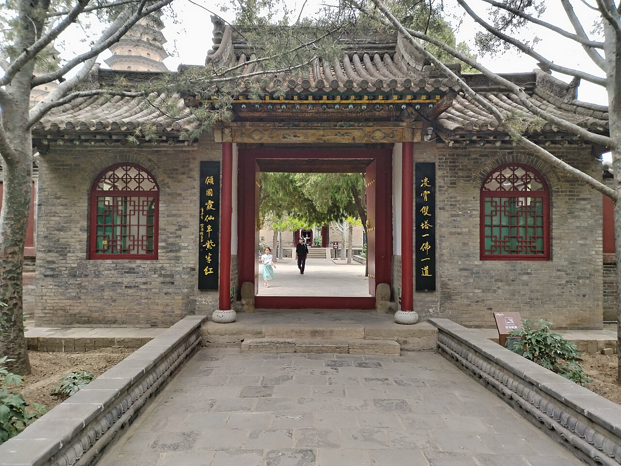 Inner gate of Yongzuo Temple with a stone-paved path leading through a red doorway