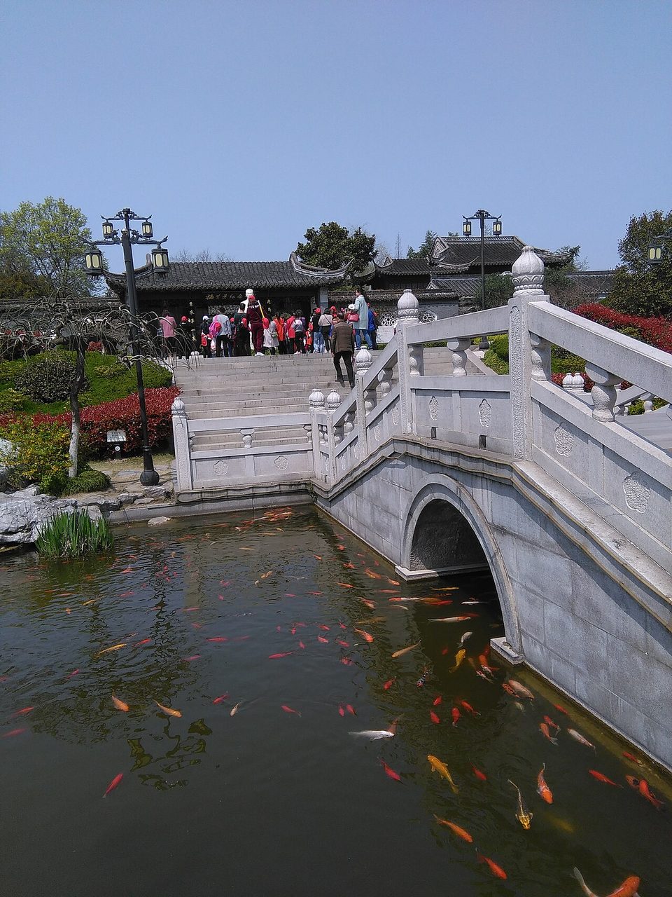 Arched stone bridge over a pond in the Mei Garden, Taizhou
