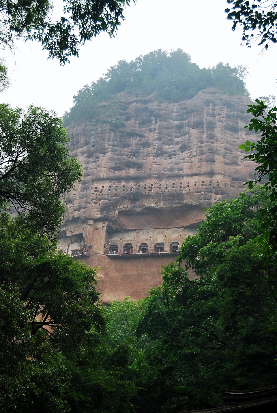 Steep stairways and walkways climbing past cave mouths on the Maijishan cliff