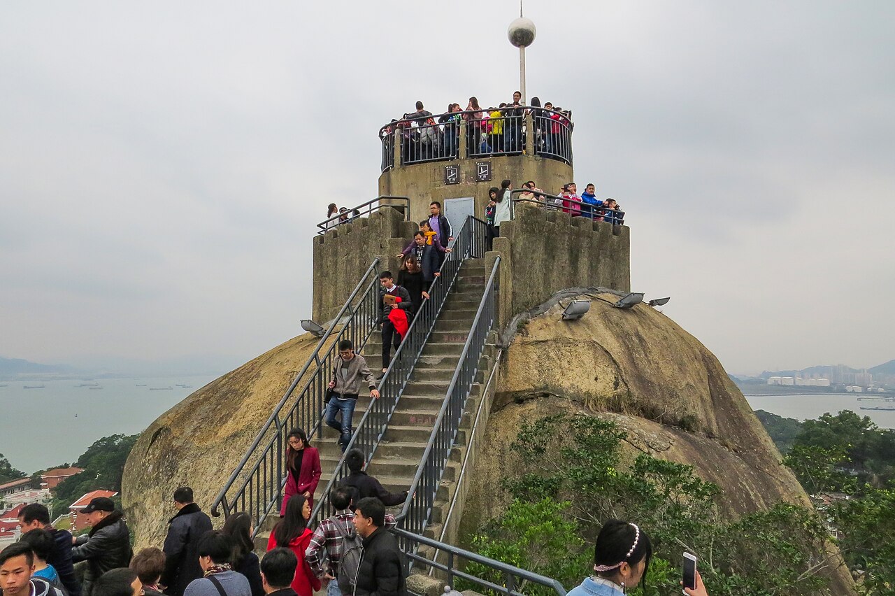 Visitors climbing the railed staircase to the summit platform of Sunlight Rock