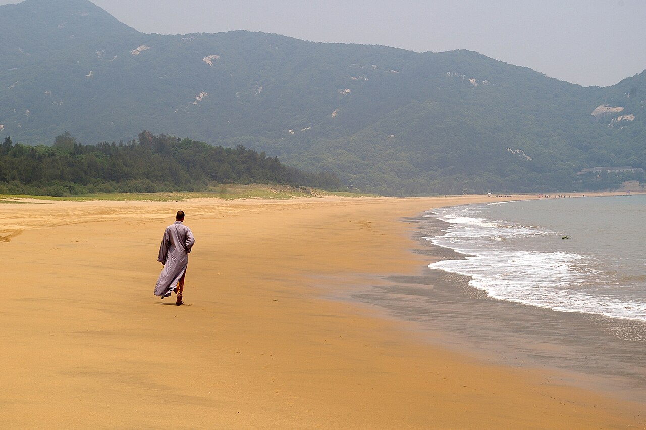 a sandy beach and rocky shore on Mount Putuo island